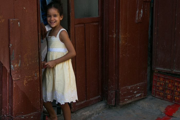Fez, Morocco 10-13-2014: Happy young girl playing by her doorstep.
