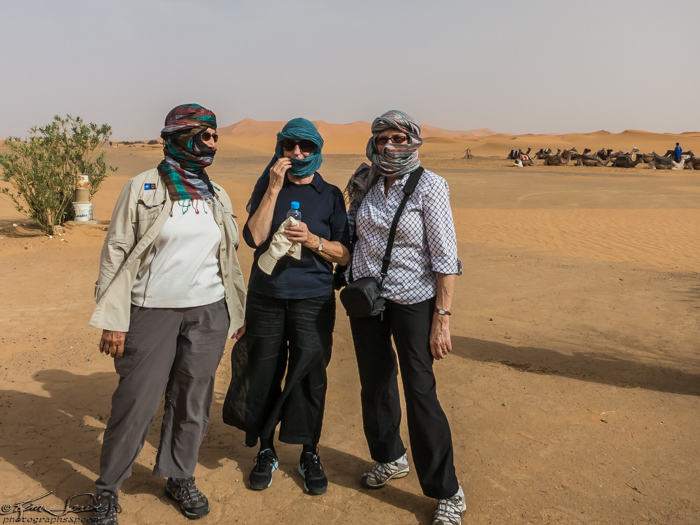 Morocco 9-15 to 17-2014, Morocco 9-15 to 9-17-2014, Sahara near Merzouga: K, A, and J preparing to ride those camels.  There was blowing sand so the face covering was most helpful.