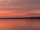 Peruvian Amazon Region, salmon color sky and water.