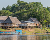 Peruvian Amazon Region, houses and boats along the shore.