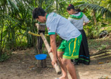 Peruvian Amazon Region, demonstrating how sugar liquid is extracted from sugar cane.