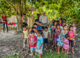 Peruvian Amazon Region, our guide Denis is trying to organize the children for a photo.  Not all are happy about that.