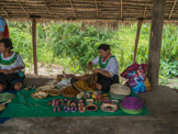 Peruvian Amazon Region, woman making a purse in the market.