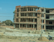 Varanasi:  on the way to the airport and home, nice new brick building, bamboo scaffolding.