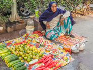 Delhi: A woman sells fresh fruit and vegetables.