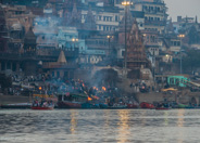 Ghats on the Ganges: Upstream a bit, the funeral fires start for the cremation ceremony.  Bodies have been brought from all around for this holy cremation.