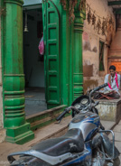 Old Varanasi: Many houses have a temple - and a motorcycle.
