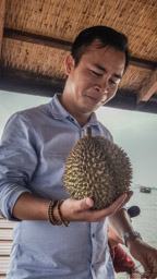 An shows us a fruit called Durian.  The fruit smells awful (note An's expression), but the fruit is nicely edible.