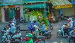 It's amazing what you see being carried on the scooters.  This looks like a whole wedding moving down the street!