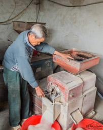 On the way to Hue, we stop at a village and meet a man who hulls rice in a hand machine.