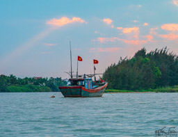 Looks like an old fishing boat, but with the two Vietnamese flags I'm nto sure.
