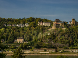 An old castle with a modern addition sits above this town.