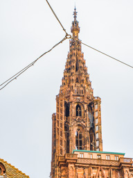 First view of the amazing details of Strasbourg Cathedral.  Seen hrough streetcar wires.