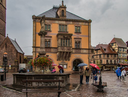 Main square of Obernai in light rain.